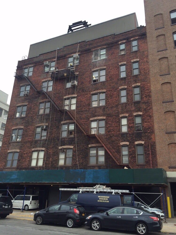 A brick building with cars parked in front of it