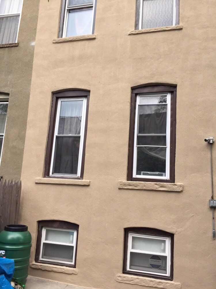 A building with a lot of windows and a green water tank.