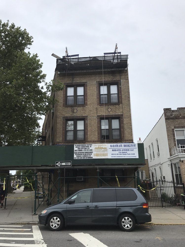 A van is parked in front of a brick building