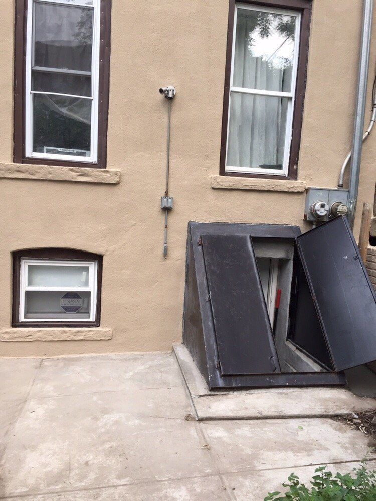 A building with two windows and a door that is open