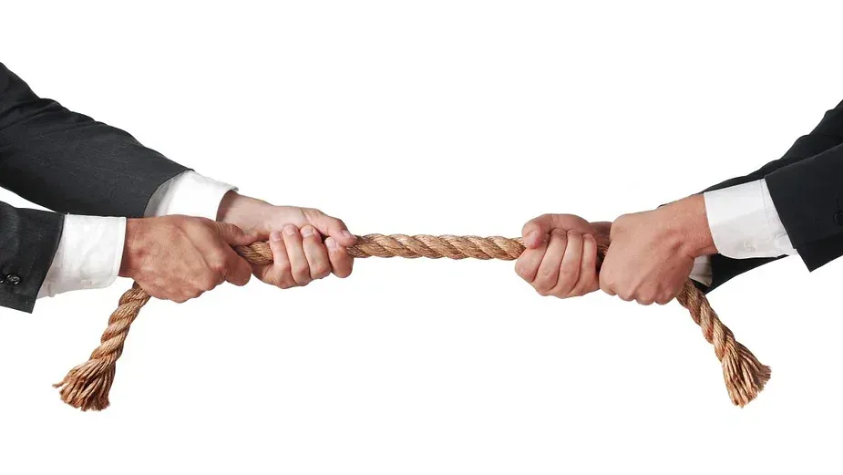 Two people tugging on rope