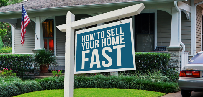 A house with a for sale sign in front of it.