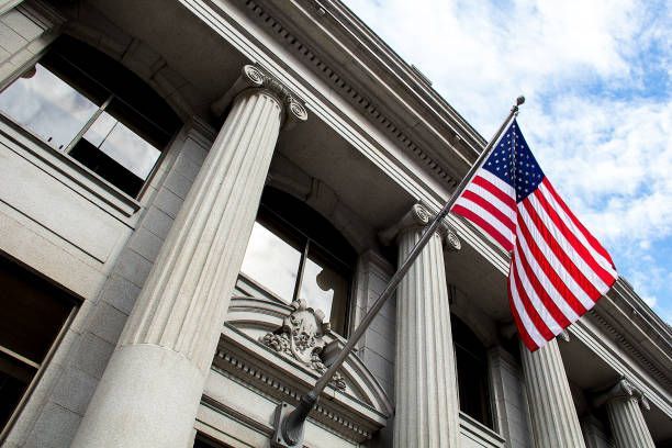 An american flag is flying in front of a building