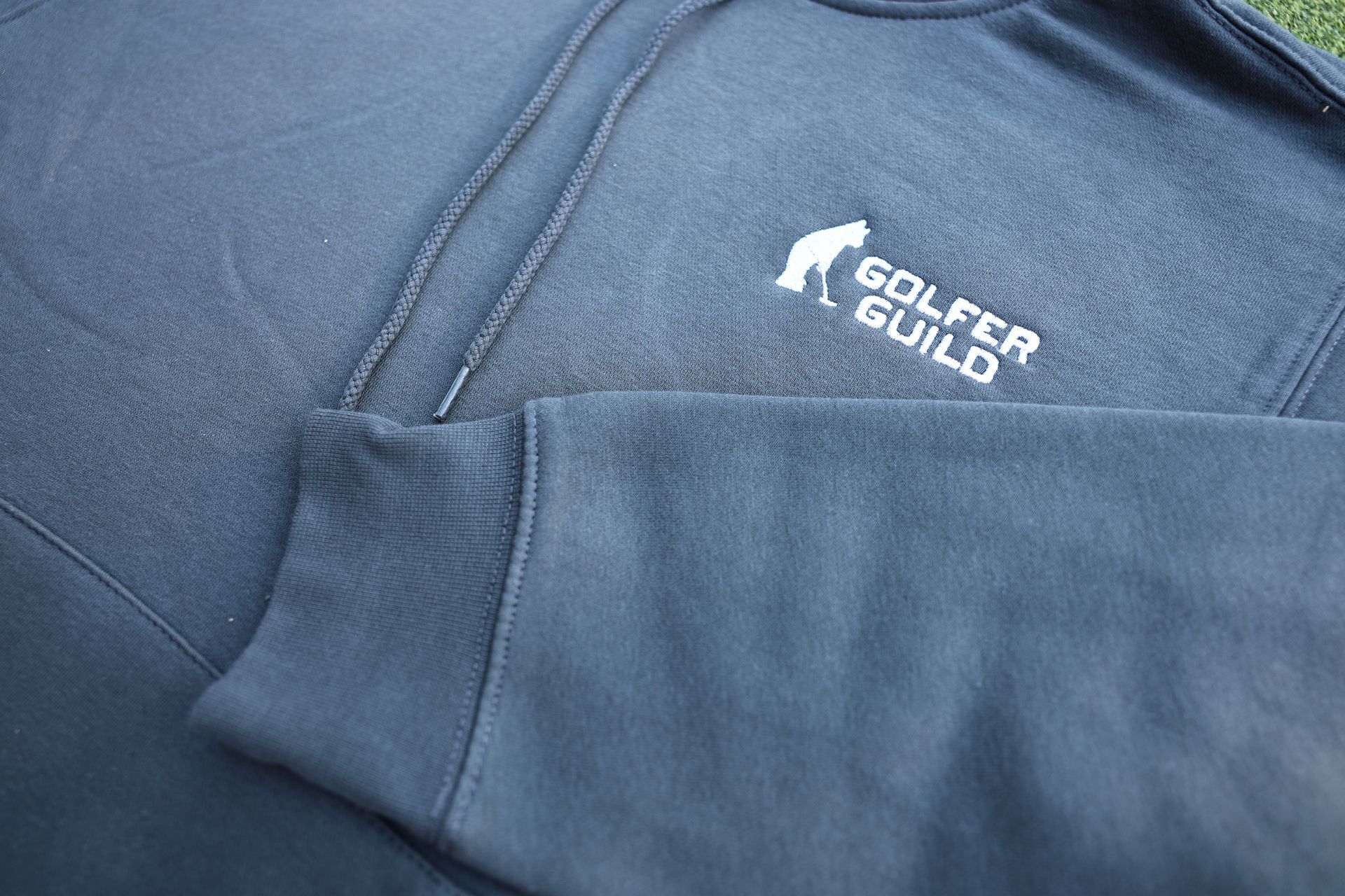 Golfer Guild Coziest Hoodie with Jonas Claesson golfing-animal art, sustainable cotton fleece