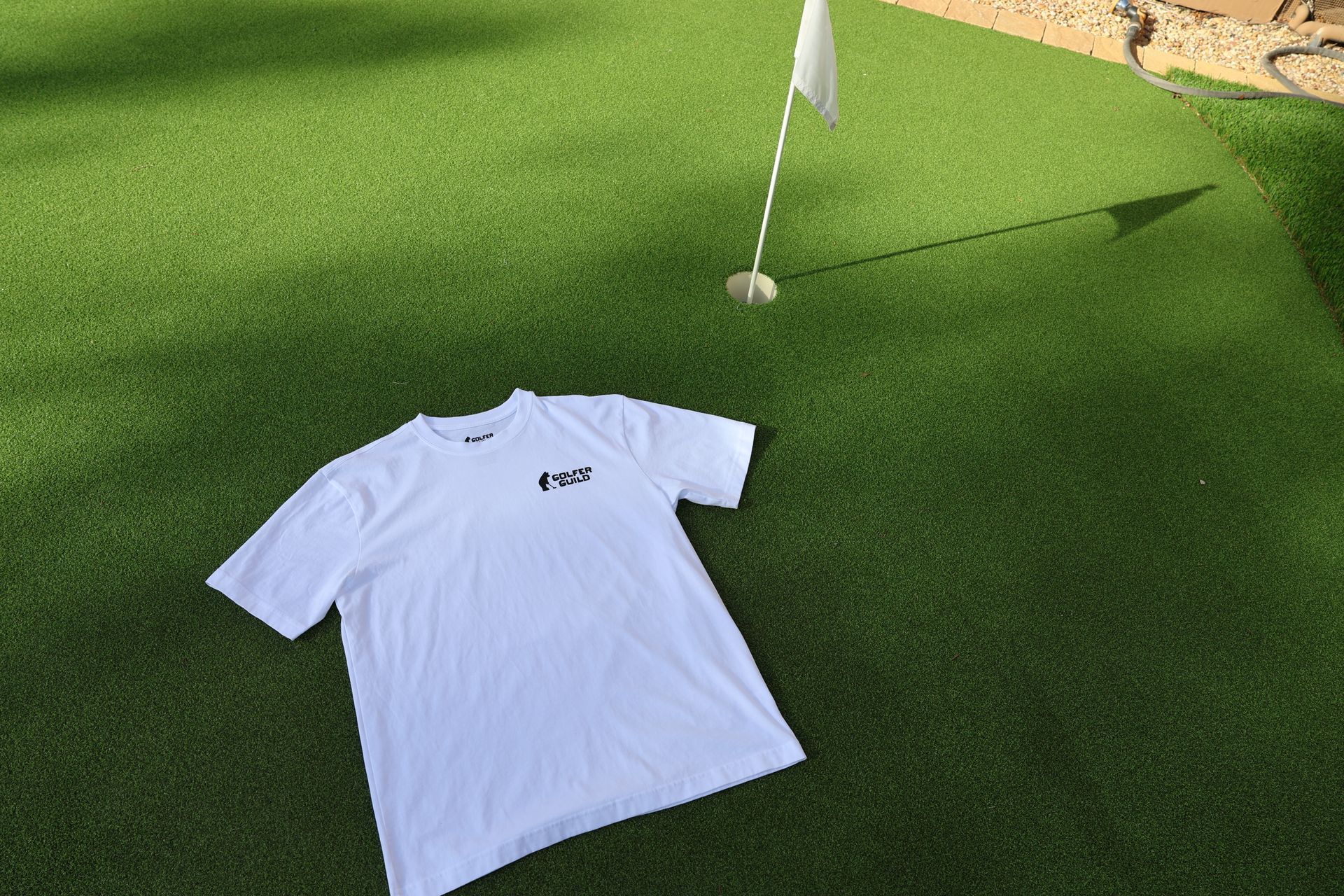 Golfer Guild SUPIMA® cotton Tartan Swinger tee with highland cow golfing animal art by Jonas Claesson.