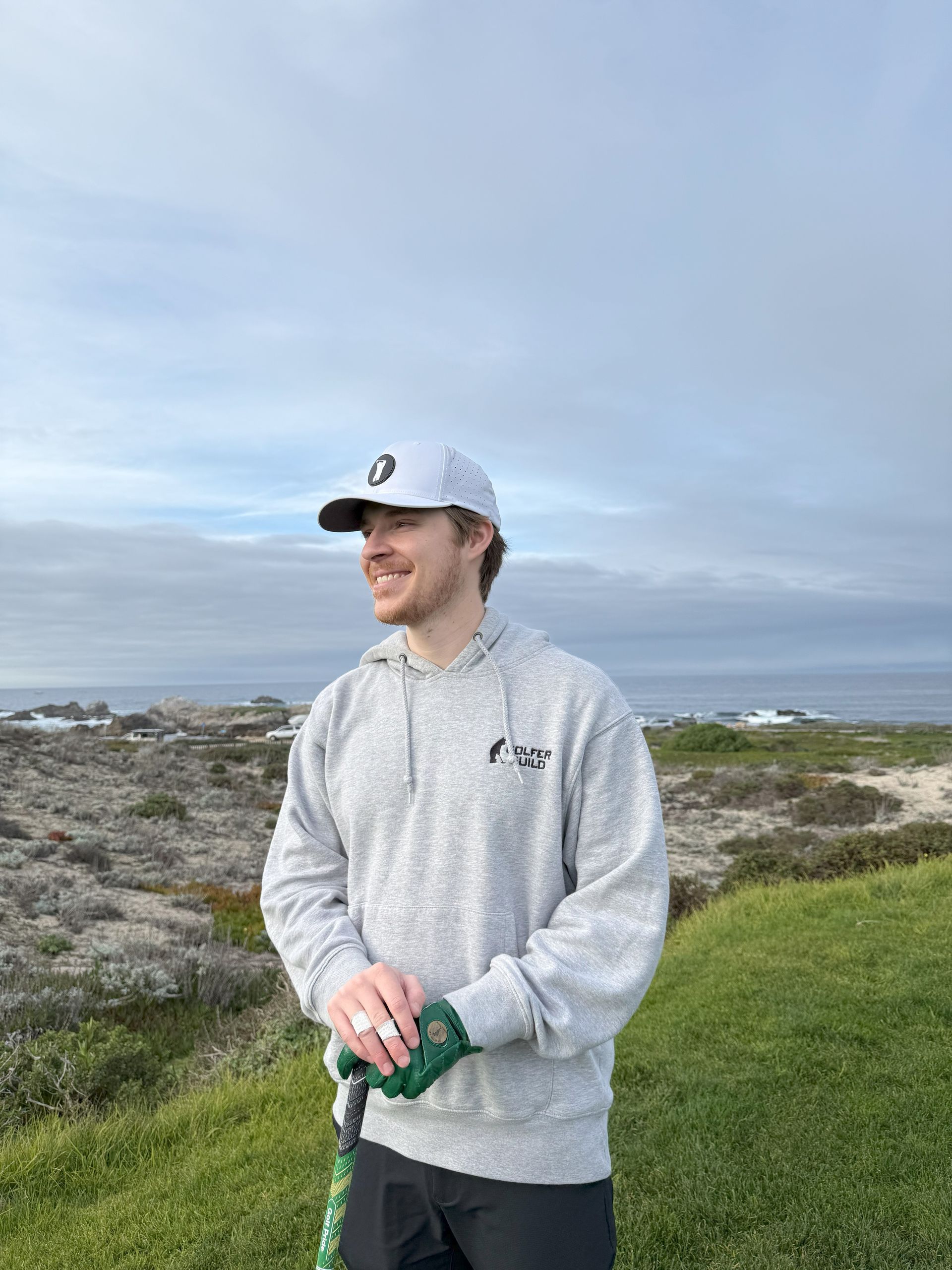 Golfer Guild Founder Vincent Del Monte golfing in the coziest hoodie in golf.