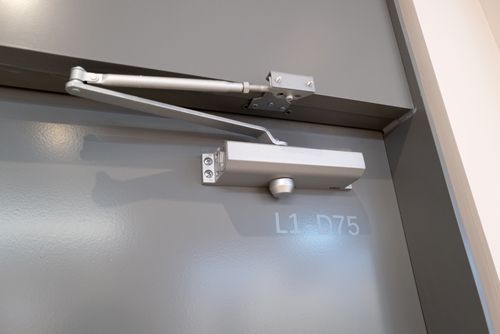 A Close Up Of A Door Closer An A Door - Bolingbrook, IL - Master Locksmithing Inc