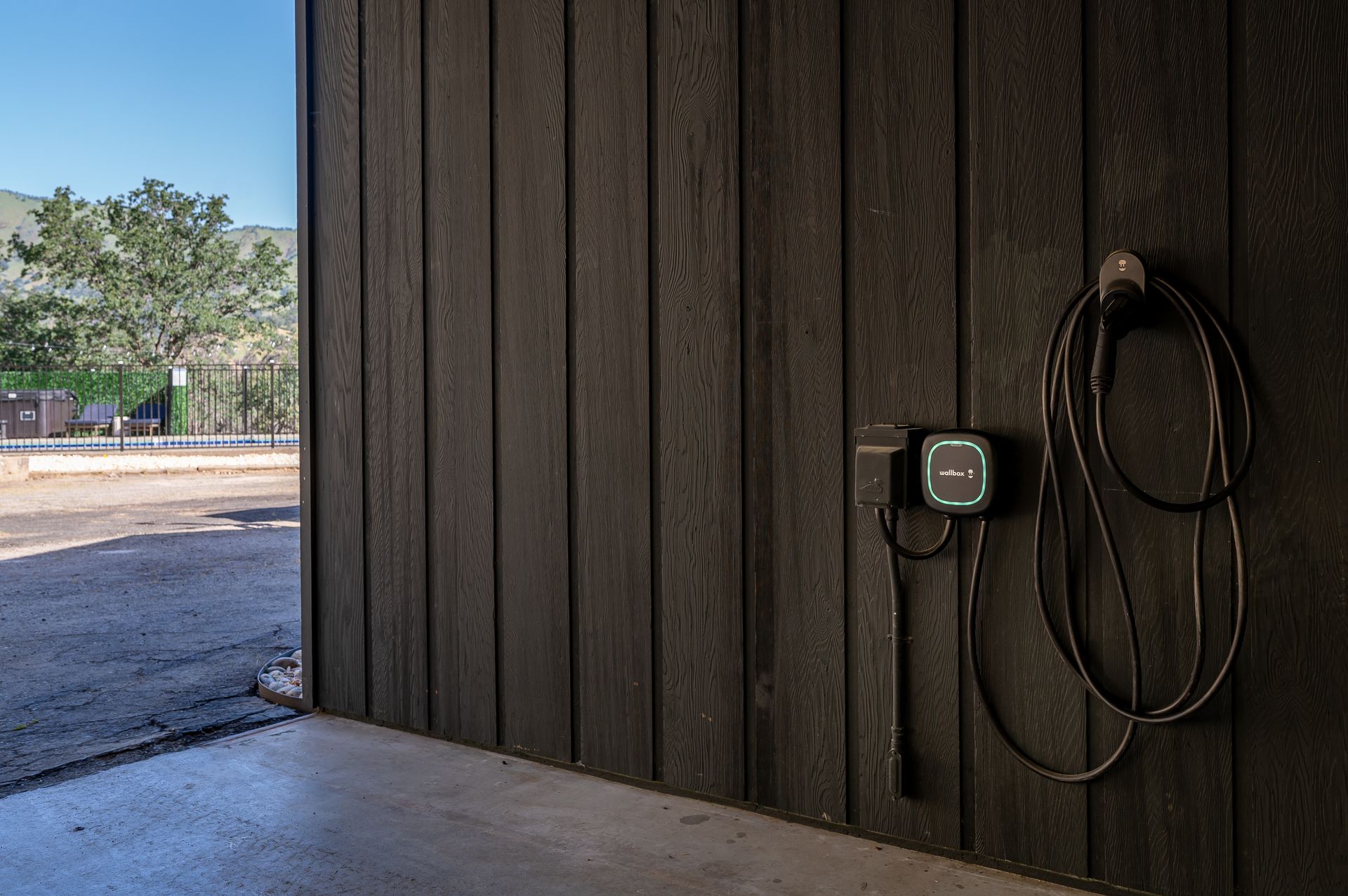 Sierra Skyline 220V EV charger in covered carport — electric vehicle charging on-site