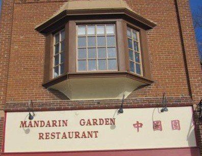 Mandarin Garden Restaurant with red brick exterior, bay window, and sign.