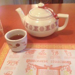 Teapot and cup of tea on a table, with Chinese Zodiac placemat.