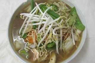 Bowl of ramen with vegetables and bean sprouts.