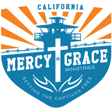 Logo for Mercy & Grace Ministries in California, featuring a guard tower and cross, with the tagline: "Setting the Captives Free."
