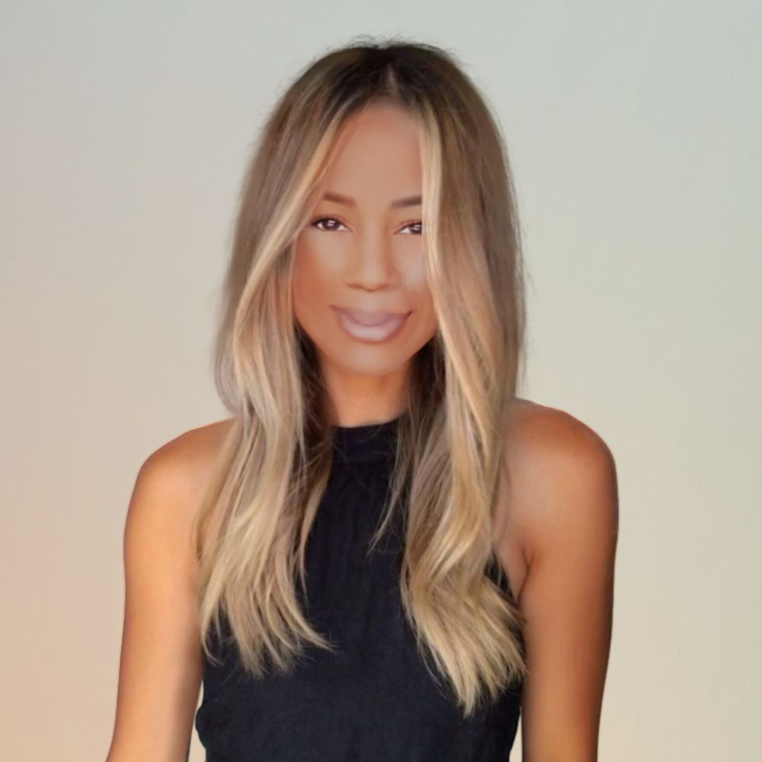 A woman with long blonde hair is wearing a black tank top