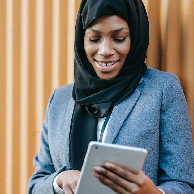 Woman looking something up on a tablet.