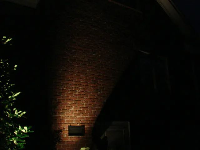 Illuminated brick wall at night.
