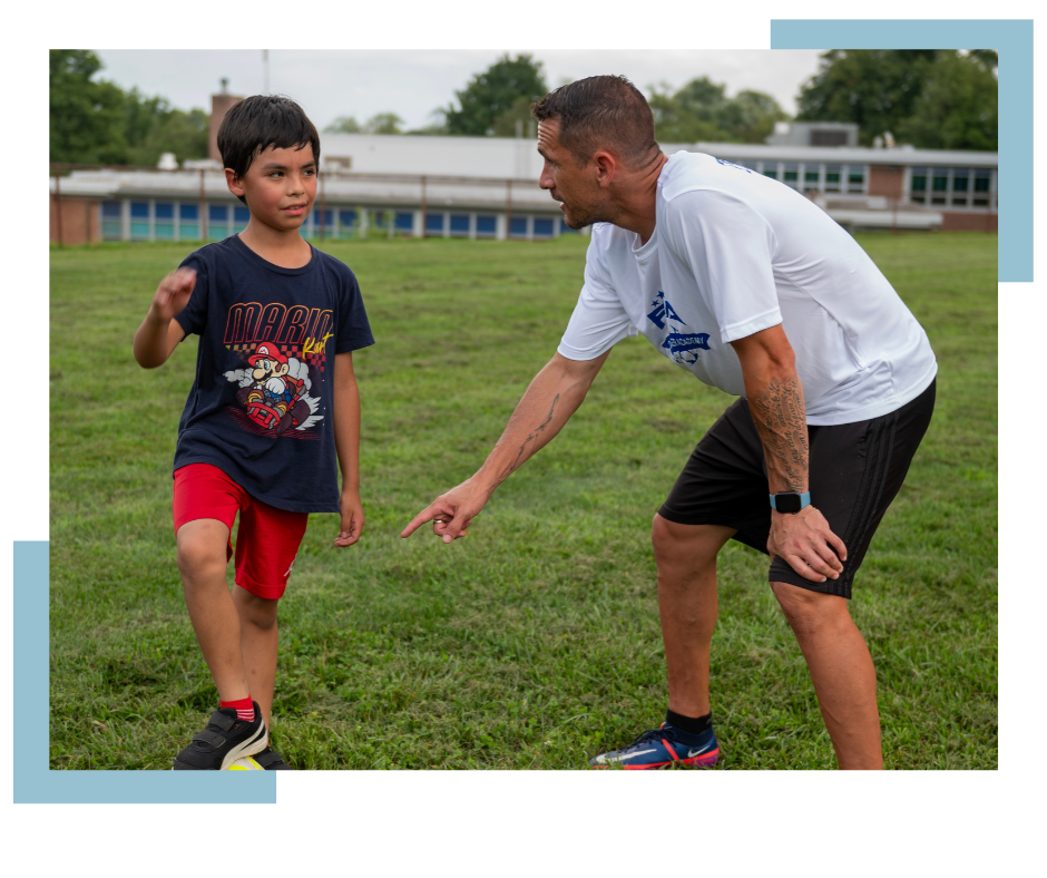 Coach Zack Flores coaching a kid with graphic squares in background