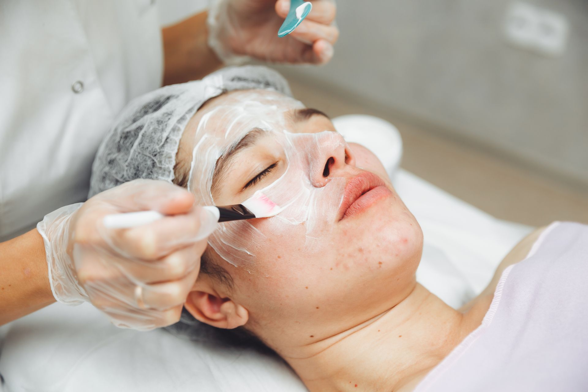 A woman is getting a facial treatment in a beauty salon.