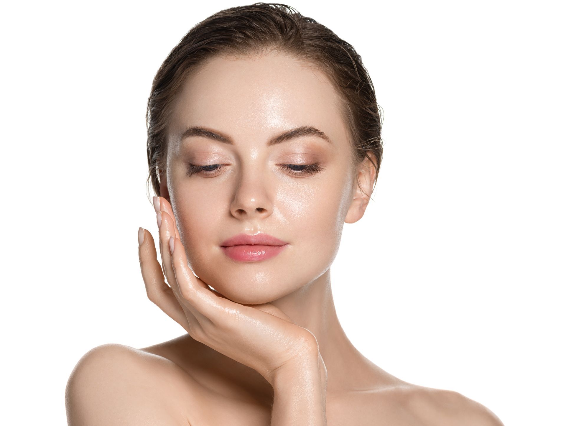 Woman with closed eyes, hand on cheek, glowing skin.