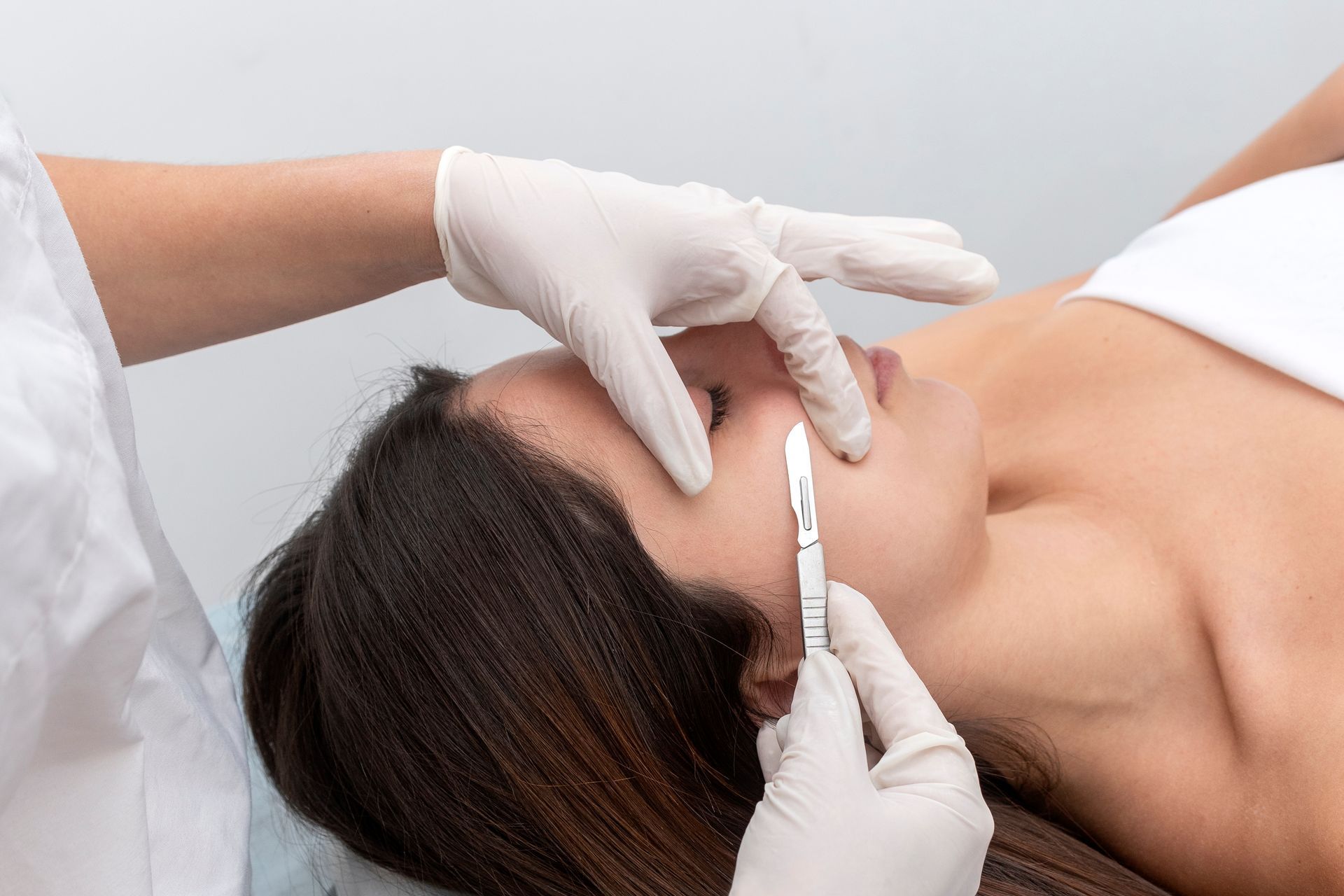 A woman is getting a facial treatment at a beauty salon.