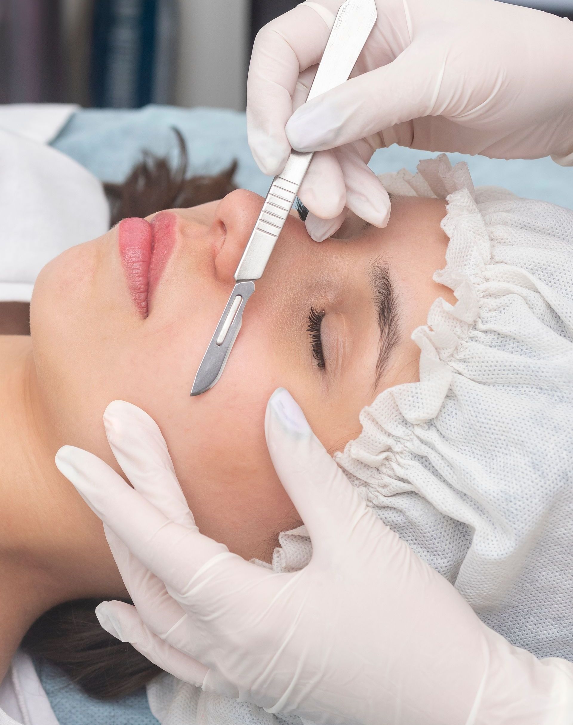 A woman is getting a surgical procedure on her face