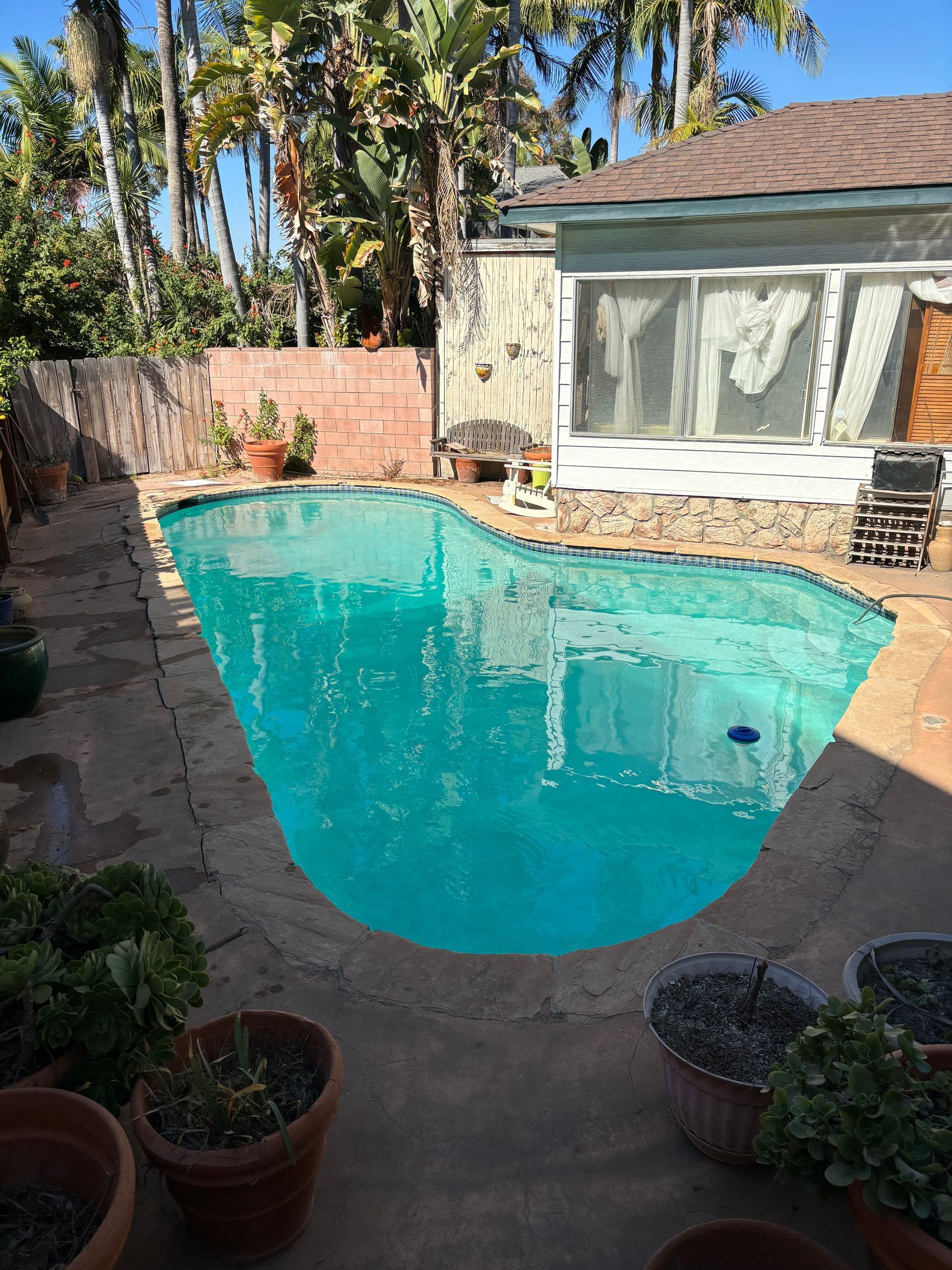 A house with a swimming pool in front of it