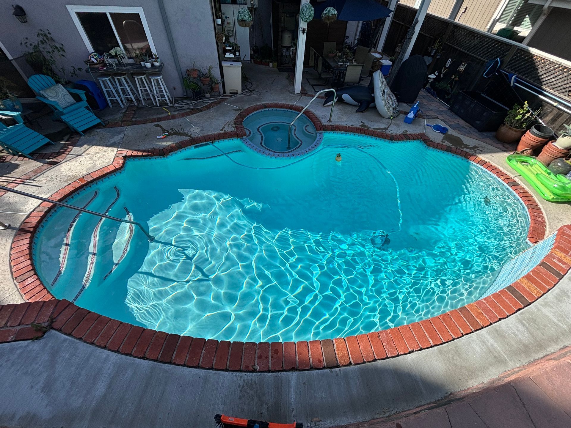 An aerial view of a swimming pool in a backyard