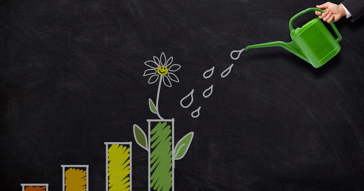 A hand holds a watering can while watering a graph that represents the reader's wealth.