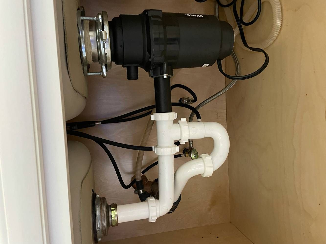 A sink with a garbage disposal underneath it