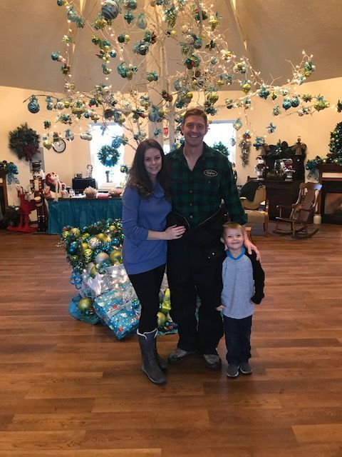 A family posing for a picture in front of a christmas tree