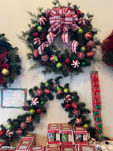 A christmas wreath with a red and white checkered bow
