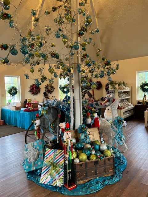 A christmas tree in a room with gifts underneath it