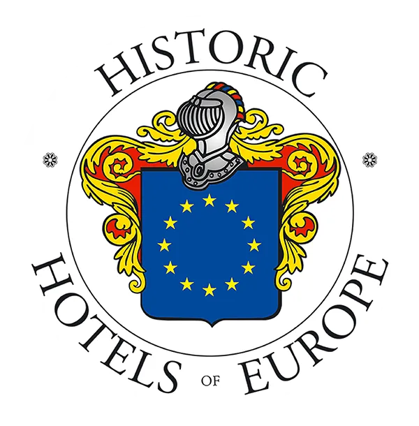 Historic Hotels of Europe logo with blue shield, gold stars, and silver helmet crest