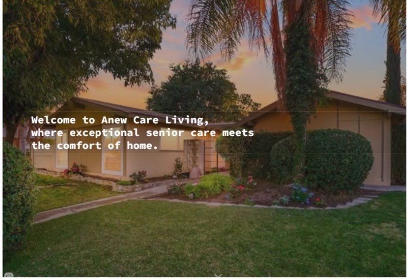 Sunset view of a care living home with palm trees, lawn, and the text “Welcome to Anew Care Living”