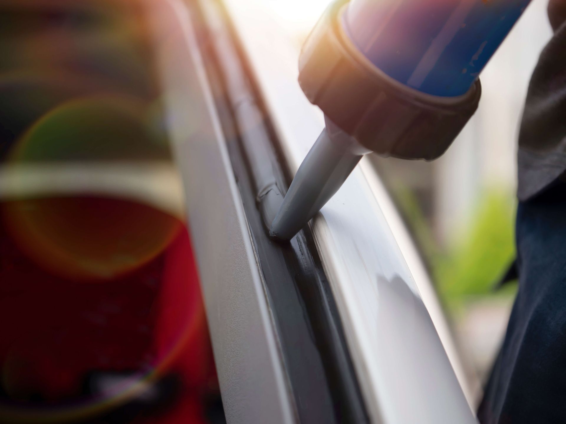 Close-up of a fuel nozzle inserted into a car’s gas tank opening.
