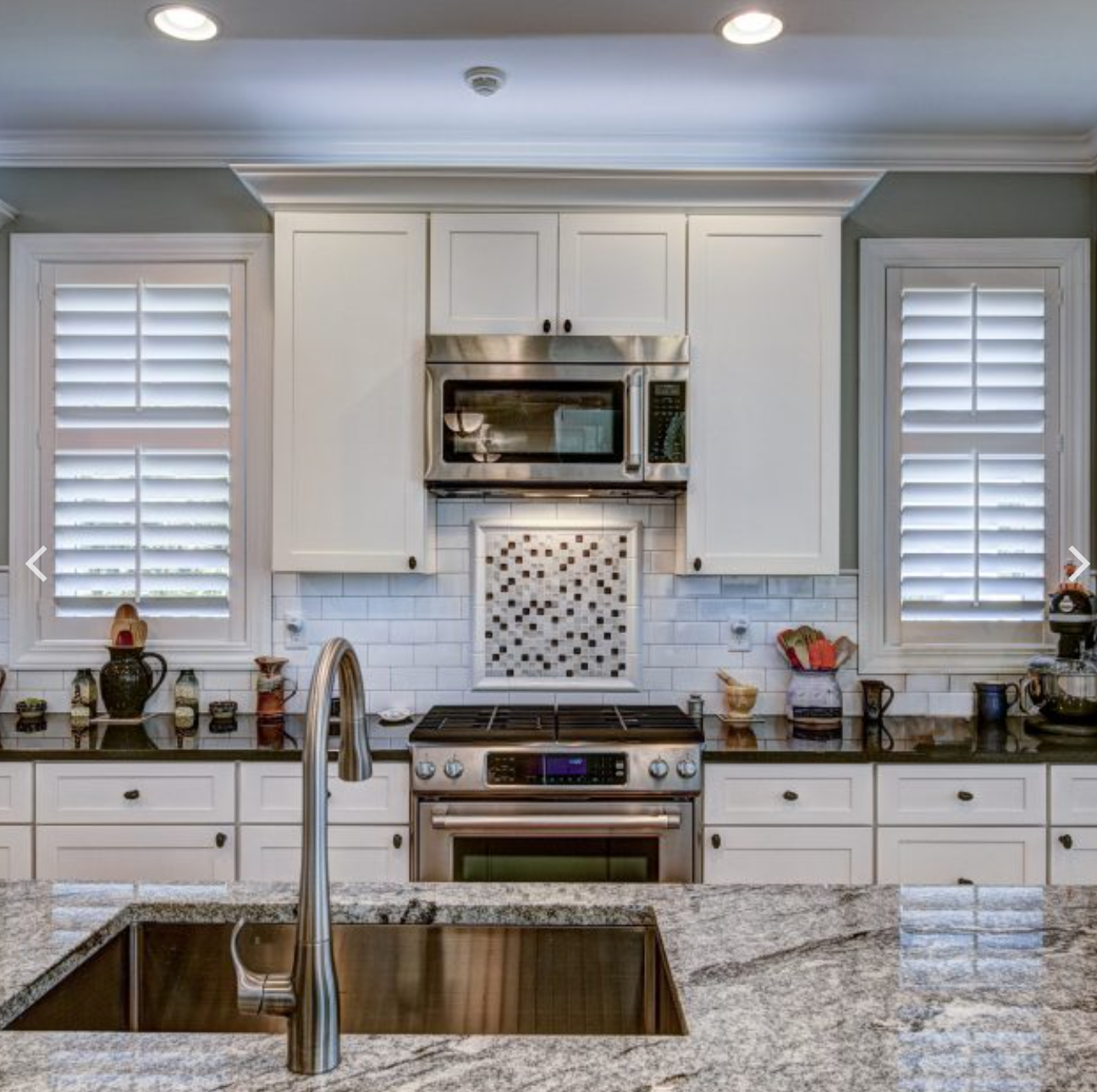 A kitchen with stainless steel appliances and granite counter tops