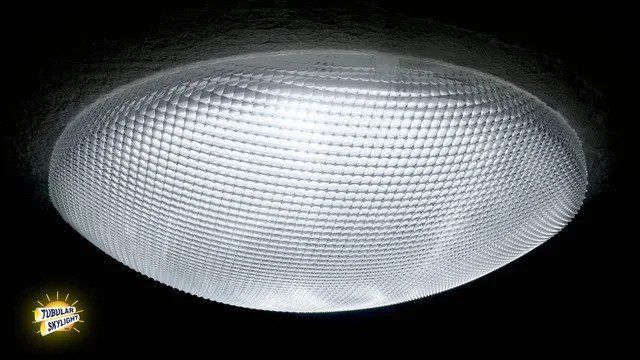 A ceiling light is lit up in a dark room.
