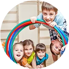 a group of children are playing with a hula hoop .