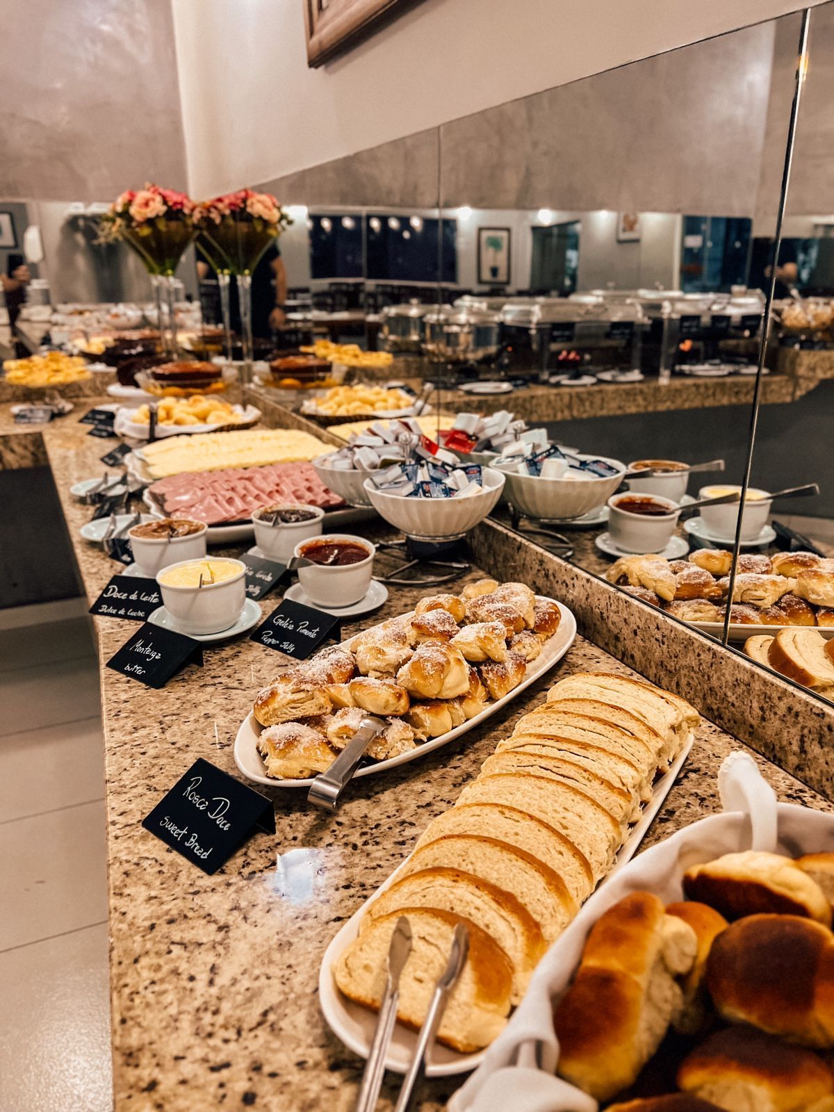 Uma grande sala de jantar com mesas e cadeiras em um restaurante.