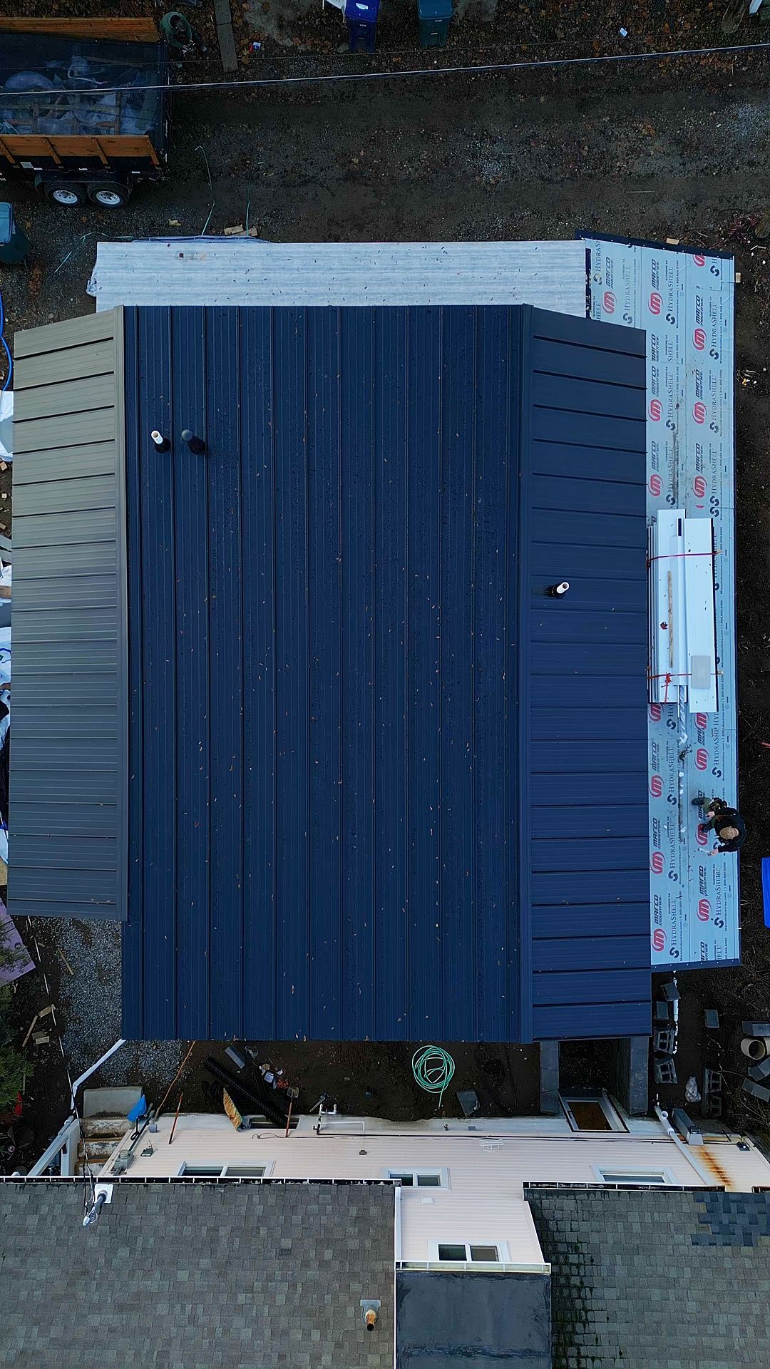Overhead view of a building under construction, metal roofing materials.