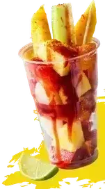 A cup filled with fruit and a lime slice.