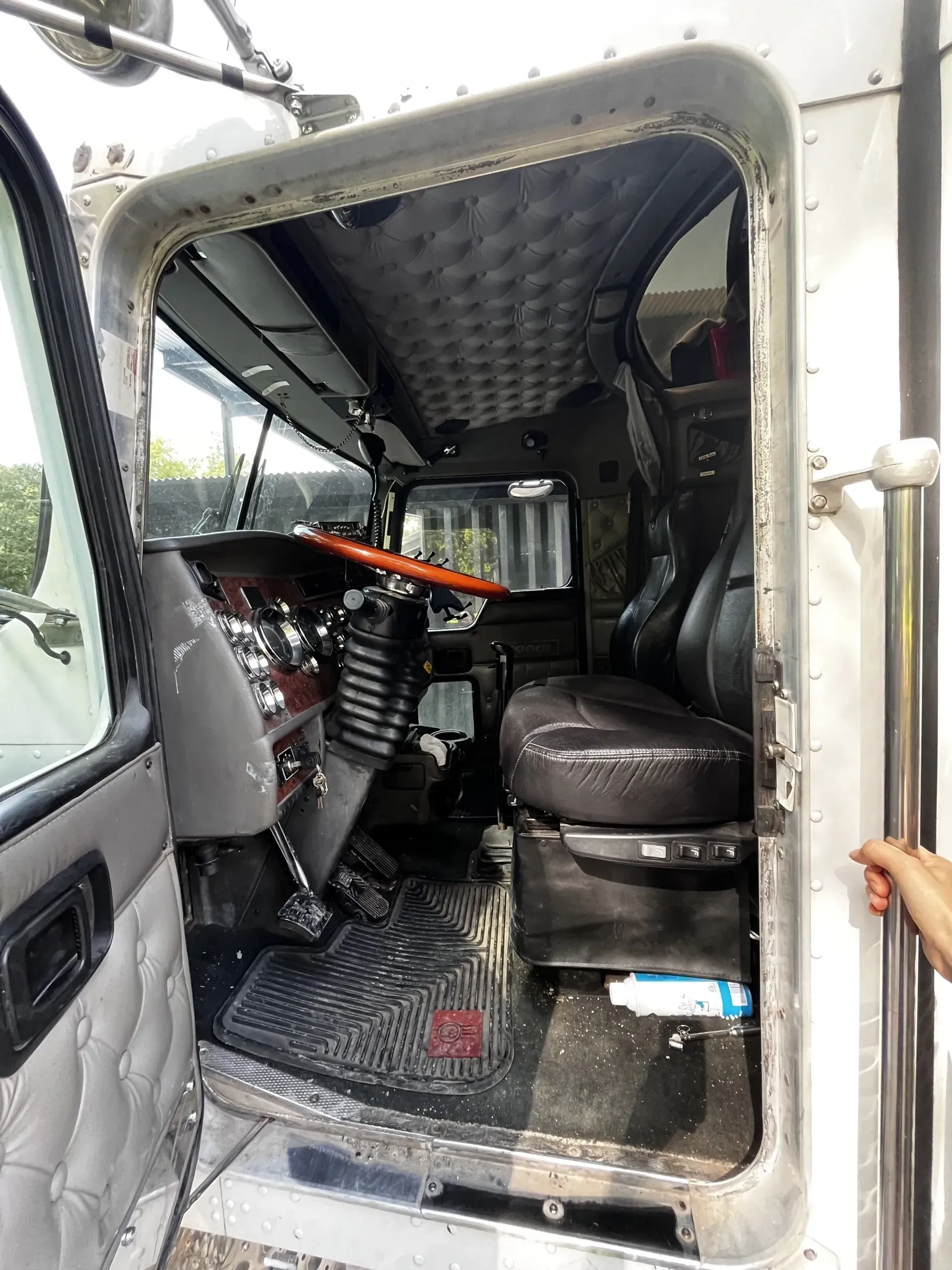A person is opening the door of a semi truck.