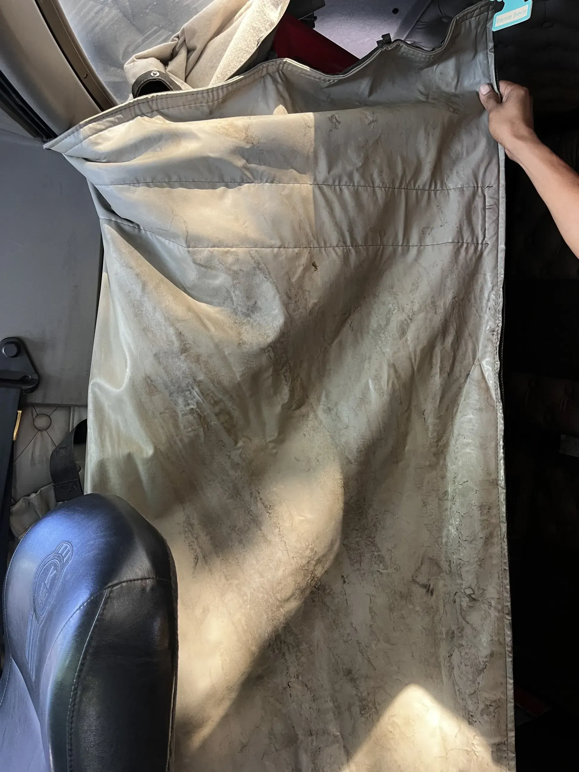 A person is holding a piece of cloth in their hand.