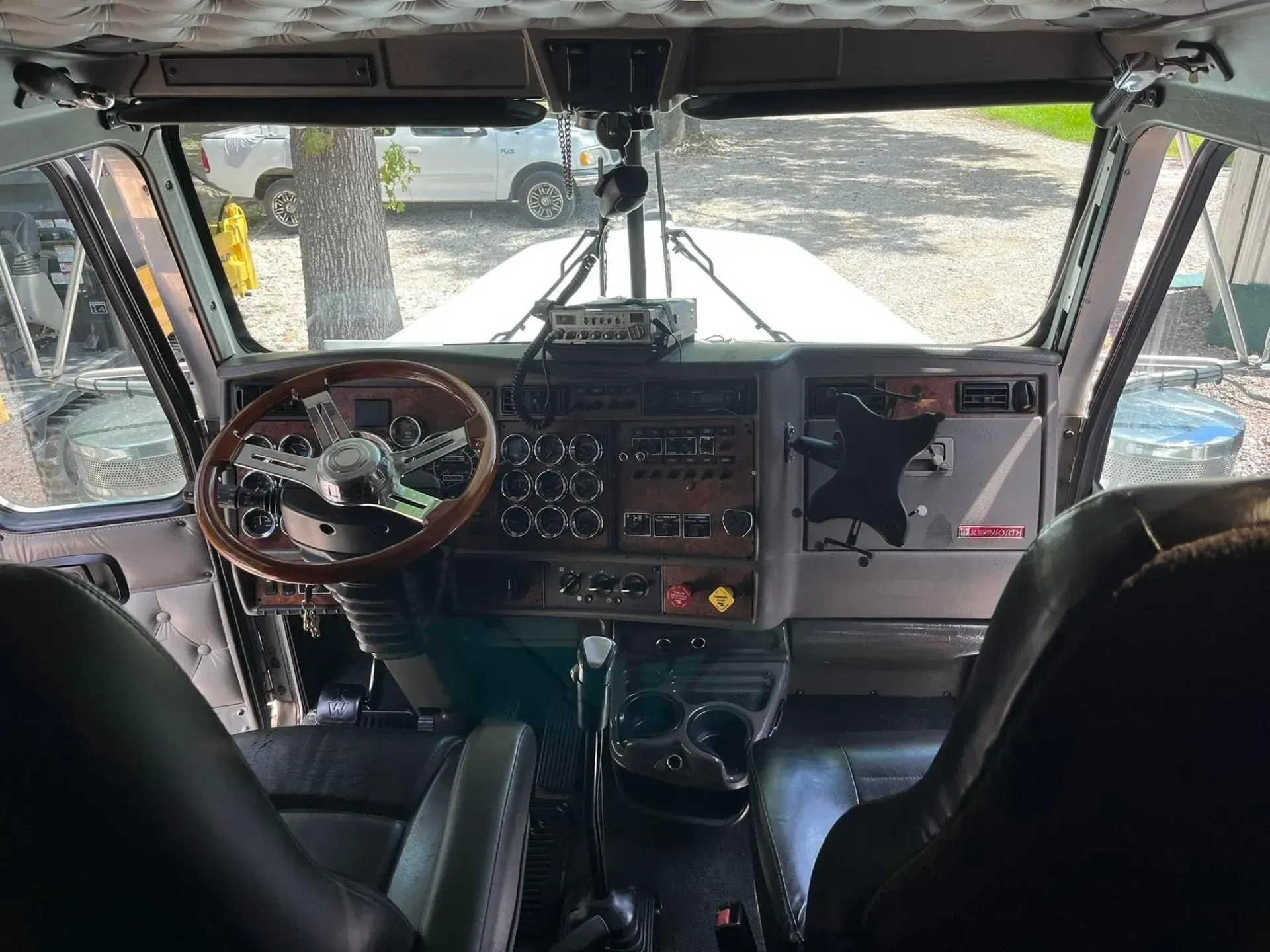 The inside of a truck with a steering wheel and seats