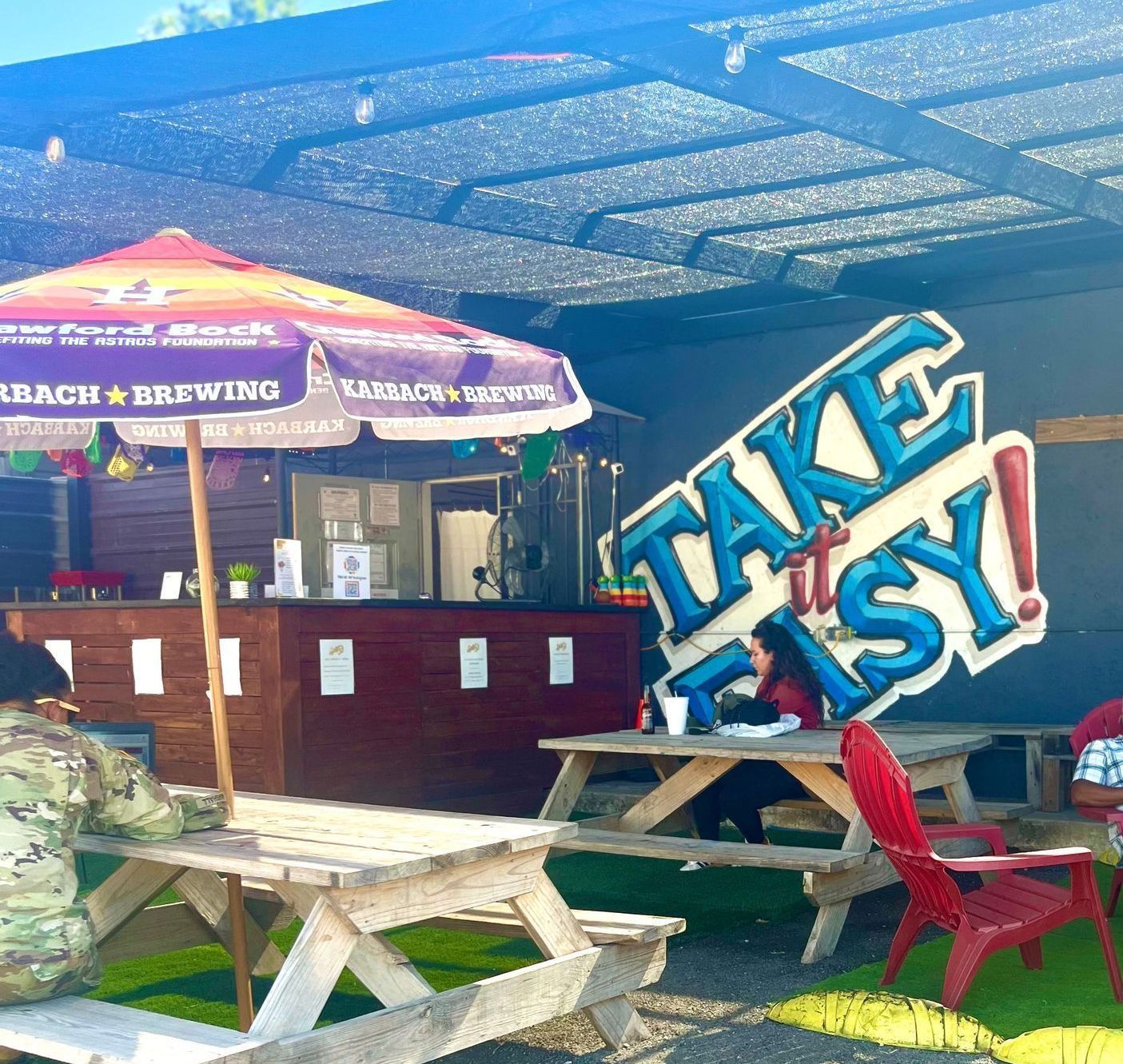A sign on the side of a building that says take it easy