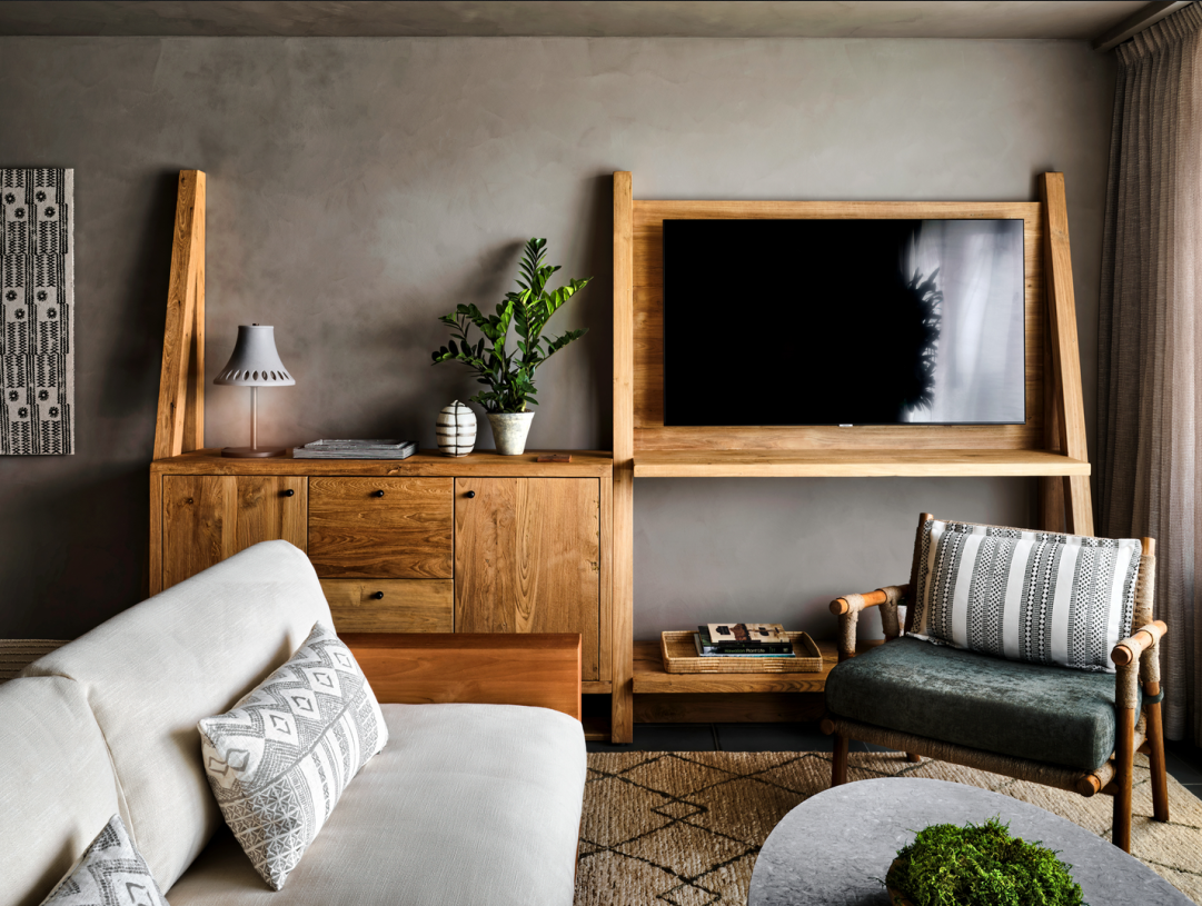 Living room with wooden furniture, gray walls, and a patterned rug.