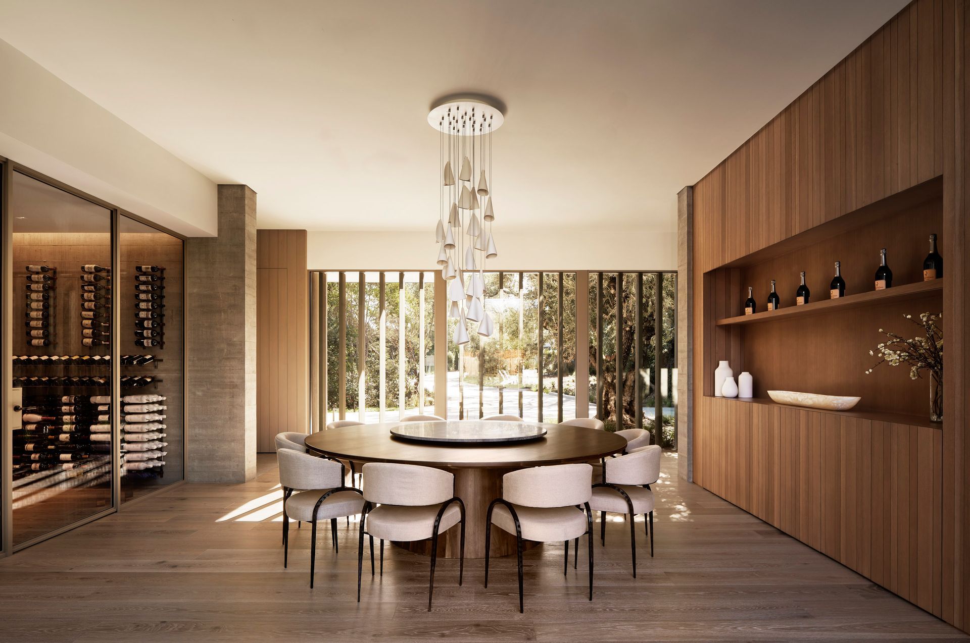 Elegant dining room with large round table, eight chairs, 