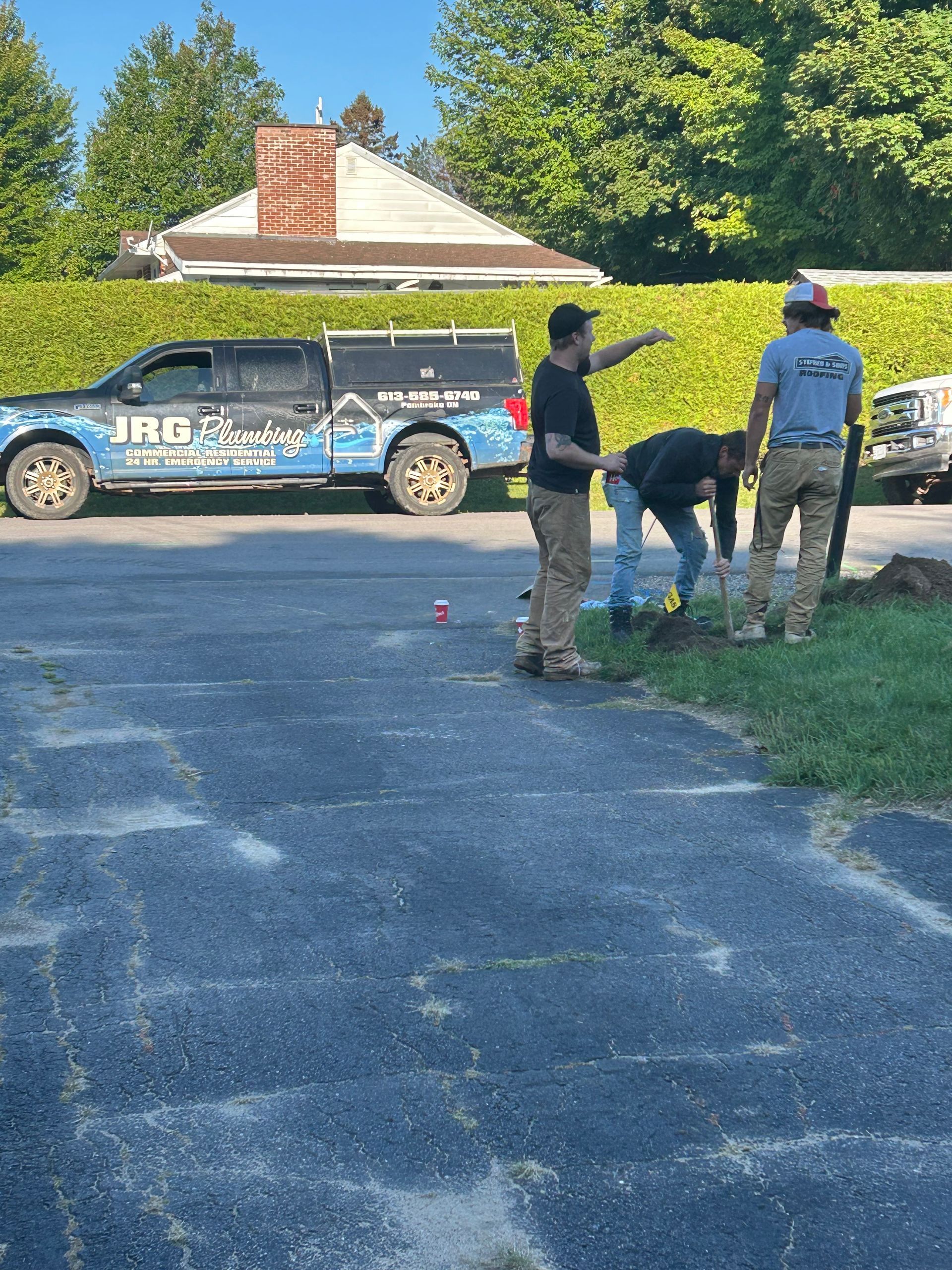 Three workers by a truck marked 