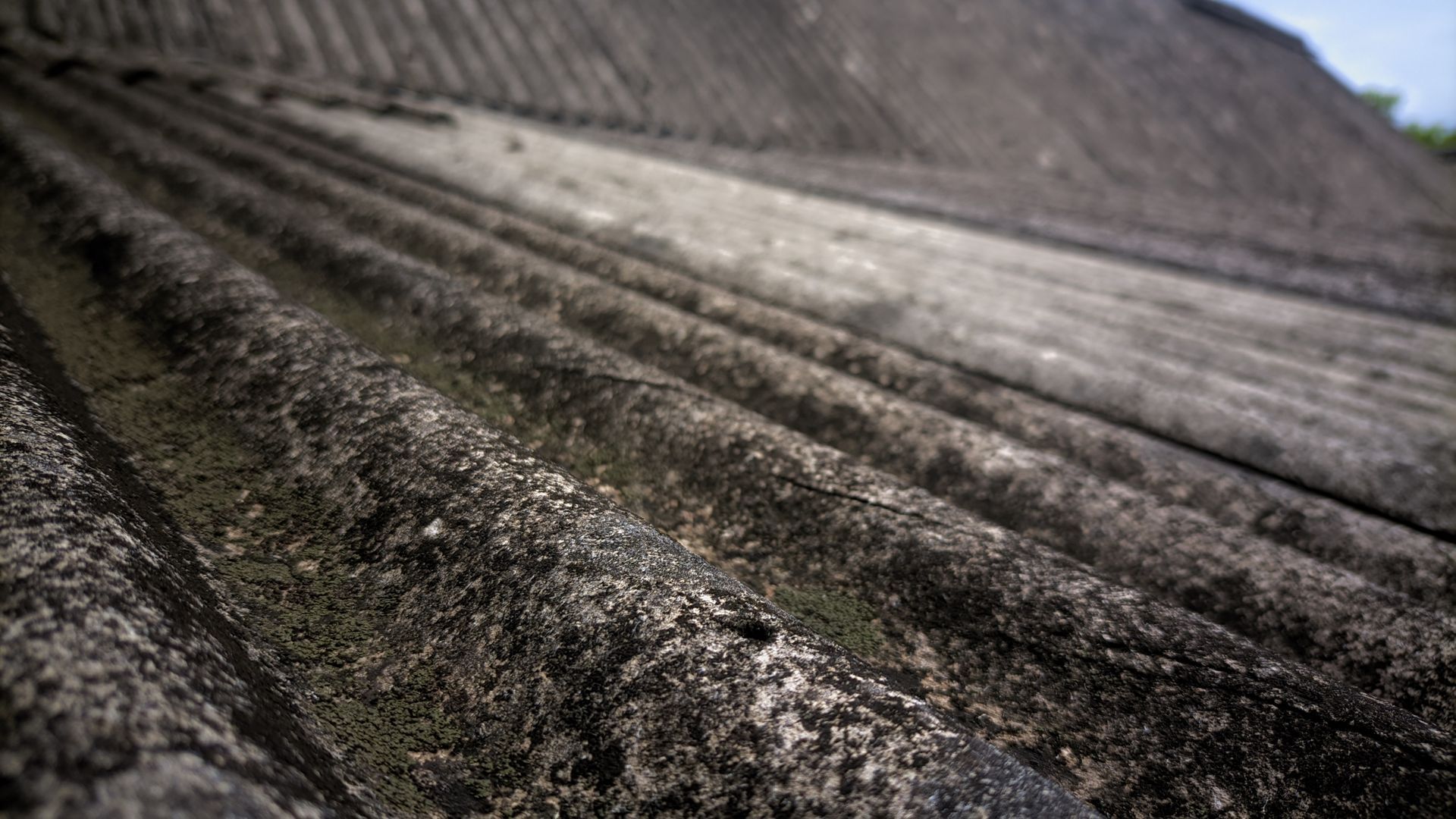 Close-up of a weathered, grooved concrete surface with dark grime and diagonal lines Close-up of a weathered, grooved concrete surface with dark grime and diagonal lines