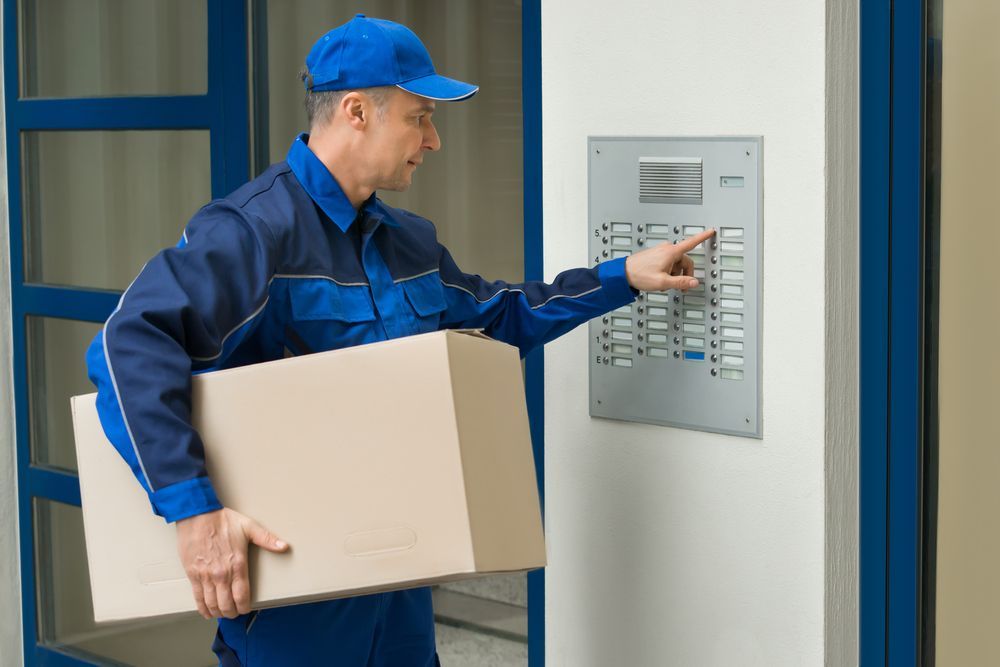 A Delivery Man at a lift to deliver a package — James Fast Freight in Wodonga, NSW