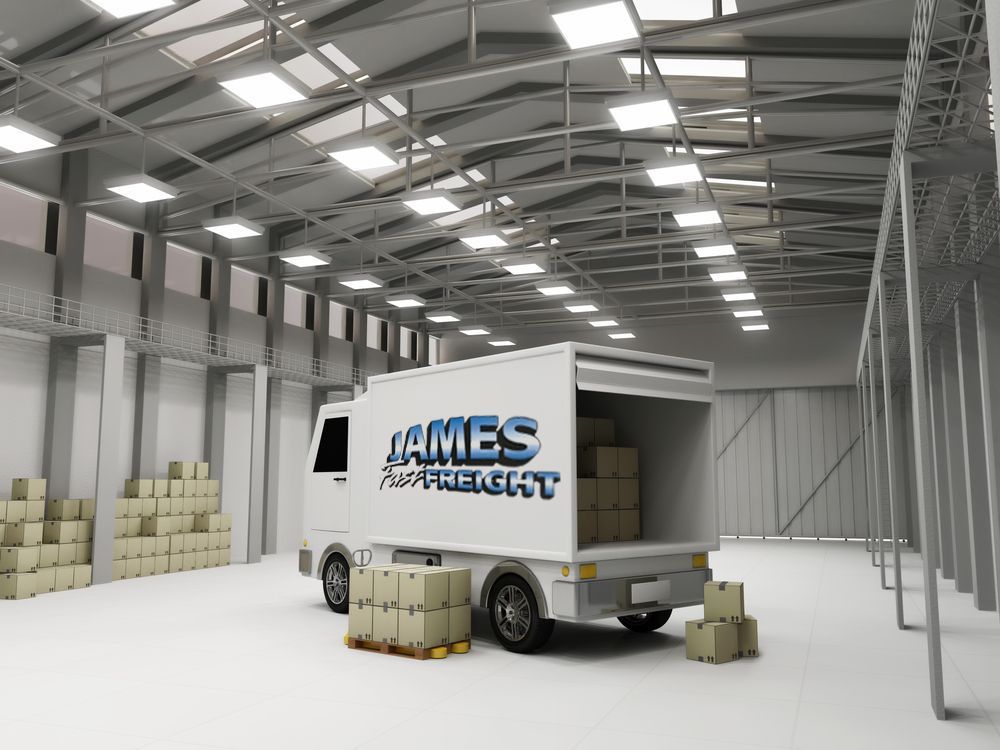 A White Truck Is Parked In A Warehouse With Boxes On The Ground — James Fast Freight in Albury, NSW